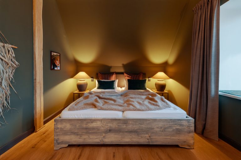 Room No.6: Double bed with wooden frame and bedside lamps, Hof Bissee