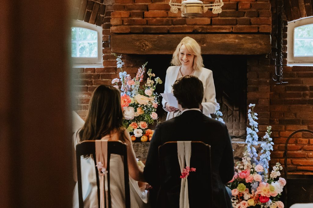 Wedding venue: Wedding ceremony in front of the fireplace with floral decorations, Hof Bissee