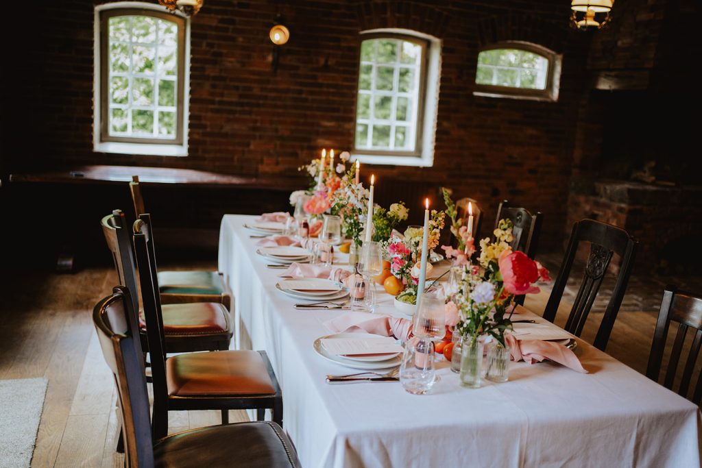 Wedding venue: Long wedding table with candles in the hall, Hof Bissee