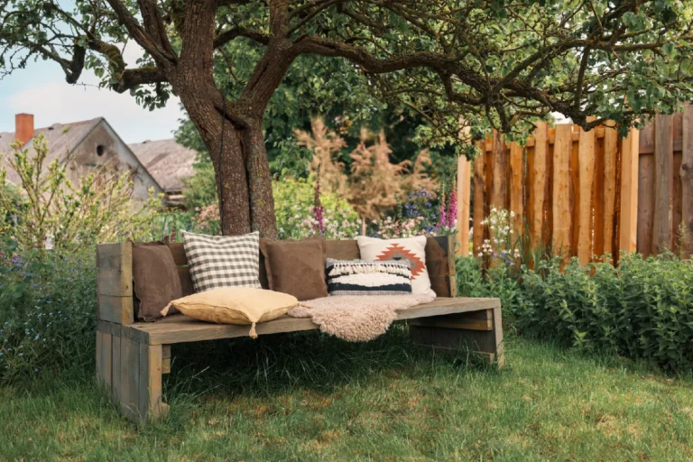 BBQ area Farmhouse: Lounge bench with cushions under the tree, Hof Bissee