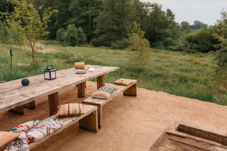 BBQ area River: Long wooden table on the sand area with a view of the meadows, Hof Bissee
