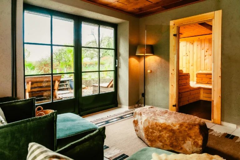 Farmhouse Spa: Relaxation room with armchair and sauna door, Hof Bissee