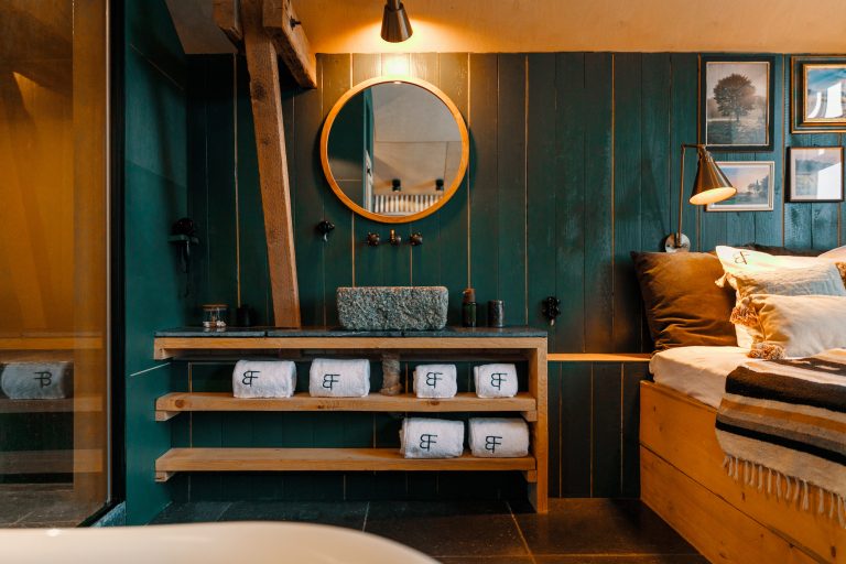 Cabin No.1: Bathroom with green walls, round mirror and stone washbasin, Hof Bissee