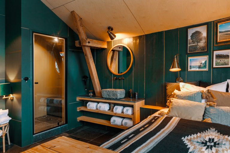 Cabin No.1: Sleeping area with glass shower and towel rack, Hof Bissee