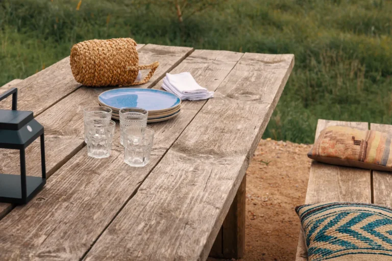 BBQ area River: Laid wooden table with lantern and glasses, Hof Bissee