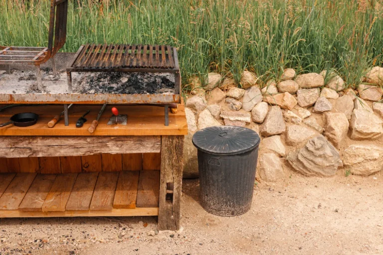 BBQ area River: Wooden outdoor grill next to the stone wall, Hof Bissee