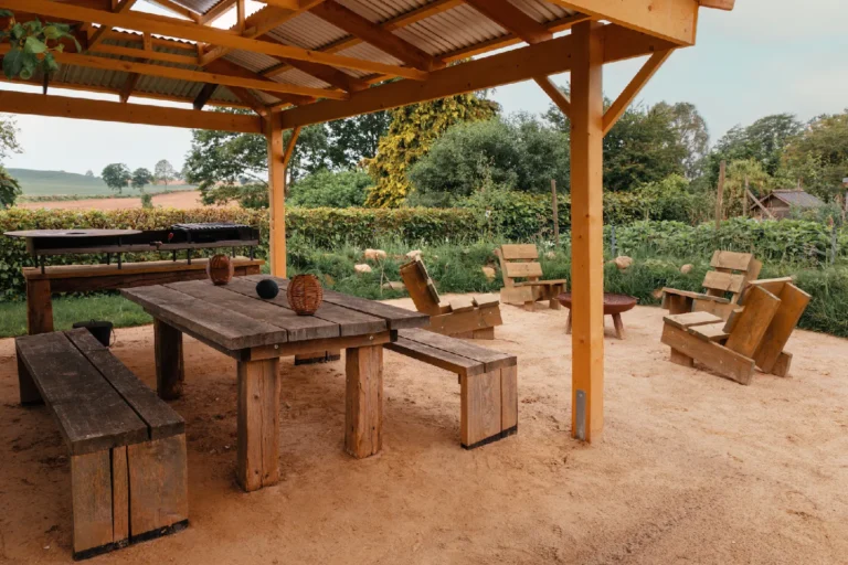 BBQ area Farmhouse: Wooden table and sun loungers under the pavilion, Hof Bissee