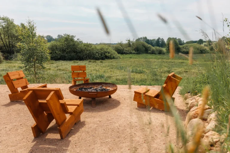 BBQ area River: Fire pit with wooden loungers at the edge of the meadow, Hof Bissee