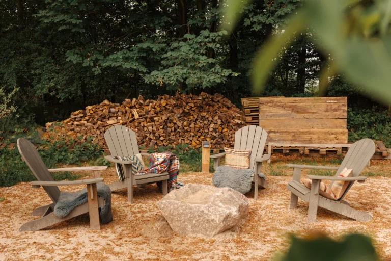 BBQ area Forrest: Adirondack chairs in a circle in front of the wood pile, Hof Bissee