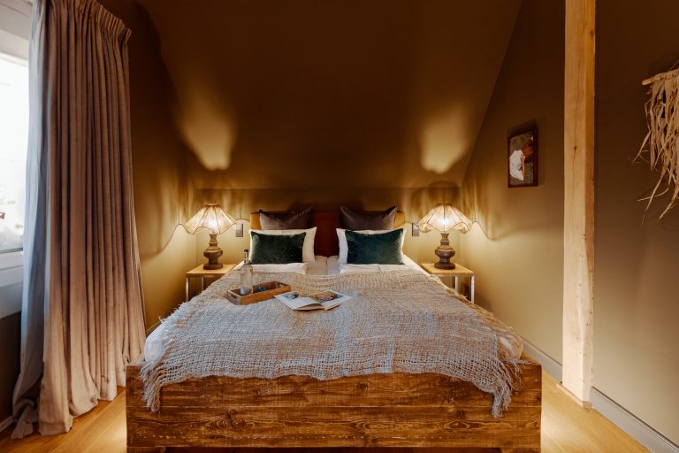 Room No.10: Double bed with wooden frame and warm lighting, Hof Bissee