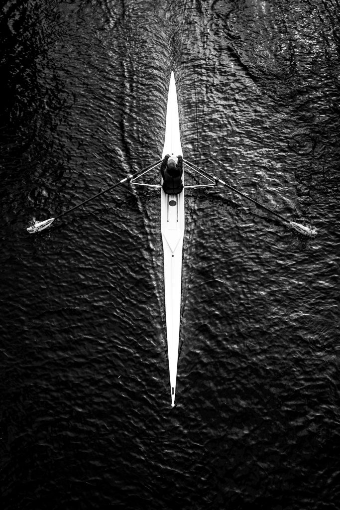 Art exhibition SVENSØN: Rowing boat from above on dark water, Hof Bissee